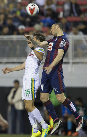 SD Eibar's Ivn Ramis (4) fights for a ball with New York Cosmos' Ruben Bover (15) during a friendly between the New York Cosmos and SD Eibar, Wednesday, May 25, 2016, at Sam Boyd Stadium in Las Ve ...