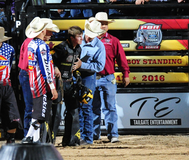 Bull rider Jess Lockwood is helped off the arena floor after riding Pitch Black to a score of 84.5 during the Professional Bull Riders Last Cowboy Standing at the Las Vegas Village grounds in Las  ...