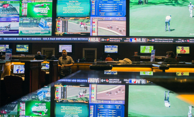 Television monitors reflect off a countertop at the Green Valley Ranch race and sports book on Thursday, May 12, 2016. The resort has added ultra-high-definition LED displays at the sports book. J ...