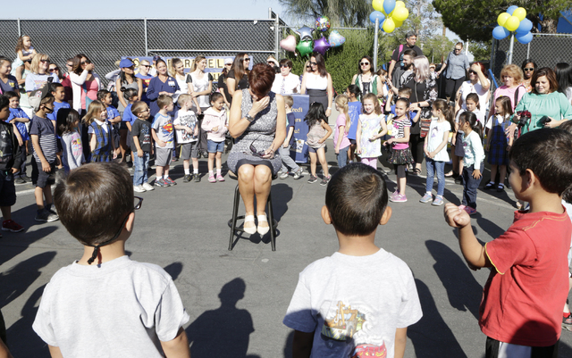Kindergarten teacher, Janet Manfredi, center, gets emotional as her students and their parents gathered during a surprise farewell and Good Luck ceremony at St. Viator School on Wednesday, May 25, ...