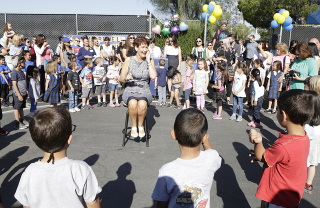 Kindergarten teacher, Janet Manfredi, center, gets emotional as her students and their parents gathered during a surprise farewell and Good Luck ceremony at St. Viator School on Wednesday, May 25, ...