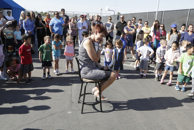 Kindergarten teacher, Janet Manfredi, center, gets emotional as her students and their parents gathered during a surprise farewell and Good Luck ceremony at St. Viator School on Wednesday, May 25, ...
