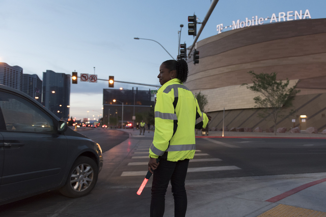 LaTia Goree of Las Vegas Traffic Control directs traffic to arena parking from Frank Sinatra Drive during T-Mobile Arena's opening day in Las Vegas Wednesday, April 6, 2016. ( Jason Ogulnik/Las Ve ...