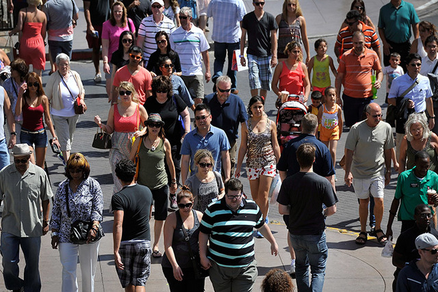 Tourists walk along the Strip on Tuesday, June 17, 2014. (David Becker/Las Vegas Review-Journal)