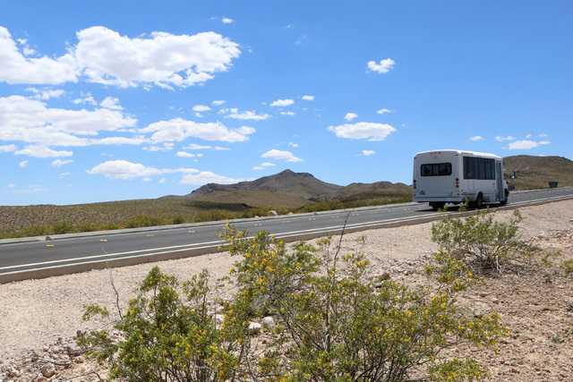 A City of Henderson shuttle bus is seen on the first paved access road to Sloan Canyon National Conservation Area on Thursday, May 19, 2016. The BLM Thursday dedicated the road and other visitor a ...