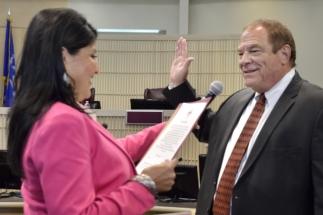 Rodney Burr, right, is sworn in as municipal judge by City Clerk Sabrina Mercadante at Henderson City Hall at 240 S. Water St. in Henderson on Tuesday, May 17, 2016. Bill Hughes/Las Vegas Review-J ...