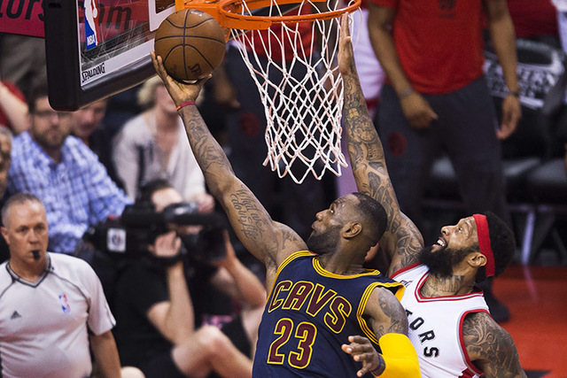 Cleveland Cavaliers forward LeBron James (23) drives past Toronto Raptors forward James Johnson during the second half of Game 6 of the NBA basketball Eastern Conference finals, Friday, May 27, 20 ...