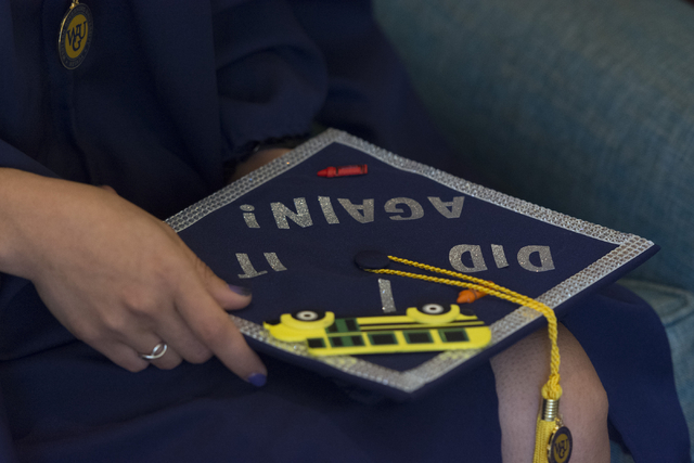 WSU Nevada graduate Silvia Mendoza-Stout holds her graduation cap as she speaks with a reporter prior to the school's first commencement ceremony at Hilton Lake Las Vegas Resort & Spa on Satur ...