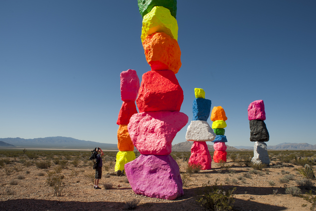 A news photographer captures Seven Magic Mountains -- a large-scale, site-specific public artwork by the artist Ugo Rondinone near the Jean Dry Lake south of Las Vegas on Monday, May 9, 2016. (Mar ...