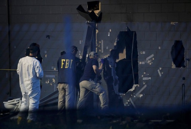 Police forensic investigators work at the crime scene of a mass shooting at the Pulse gay night club in Orlando, Florida, U.S. June 12, 2016.   (Jim Young/Reuters)