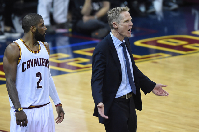 Golden State Warriors head coach Steve Kerr reacts after a call in front of Cleveland Cavaliers guard Kyrie Irving (2) during the fourth quarter in game six of the NBA Finals at Quicken Loans Aren ...
