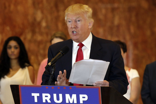 Republican presidential candidate Donald Trump reads from a list of donations to veteran's groups, during a news conference in New York, Tuesday, May 31, 2016. (Richard Drew/AP)