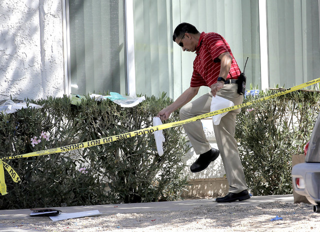 A Phoenix police detective exits  a home, Thursday, June 2, 2016 in Phoenix where three boys were killed during a several hour period Wednesday night.  The boy's mother was hospitalized in critica ...