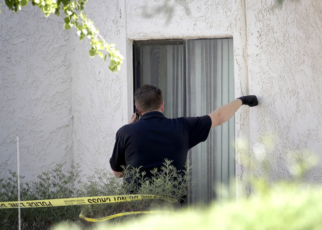 A Phoenix police detective stands outside a home, Thursday, June 2, 2016 in Phoenix where three boys were killed during a several hour period Wednesday night.  The boy's mother was hospitalized in ...