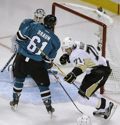 Pittsburgh Penguins' Evgeni Malkin, right, celebrates after scoring a goal against San Jose Sharks goalie Martin Jones and Justin Braun (61) during the second period of Game 4 of the NHL hockey St ...