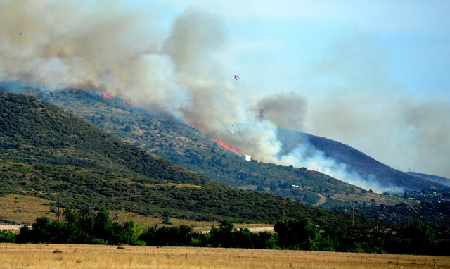 A brush fire burns in Yarnell, Ariz., Wednesday, June 8, 2016. The brush fire threatened structures in north-central Arizona, the scene of a 2013 wildfire in which 19 members of an elite firefight ...