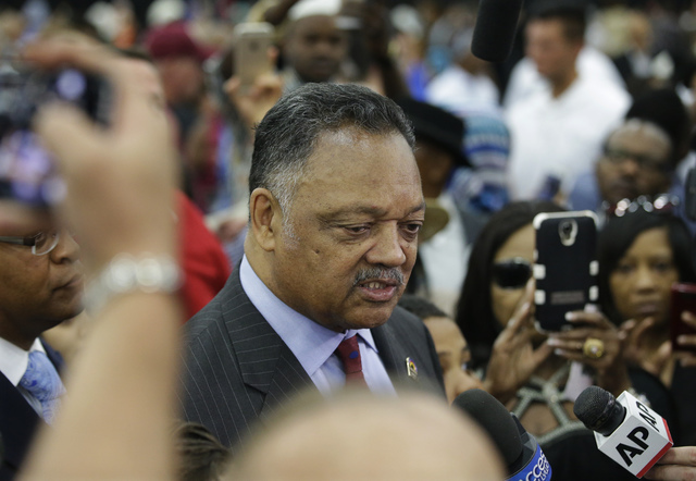 American civil rights activist Jesse Jackson speaks to members of the media before Muhammad Ali's Jenazah, a traditional Islamic Muslim service, in Freedom Hall, Thursday, June 9, 2016, in Louisvi ...
