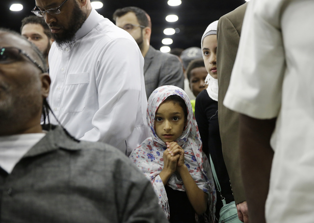 Eight-year-old Layla Selenica waits for Muhammad Ali's Jenazah, a traditional Islamic Muslim service, in Freedom Hall, Thursday, June 9, 2016, in Louisville, Ky. (David Goldman/AP)