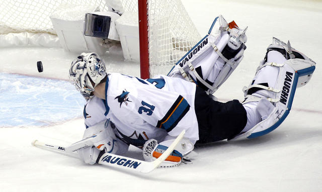 San Jose Sharks goalie Martin Jones watches the puck shot for a goal by Pittsburgh Penguins' Evgeni Malkin rattle out of the net during the first period in Game 5 of the NHL hockey Stanley Cup Fin ...