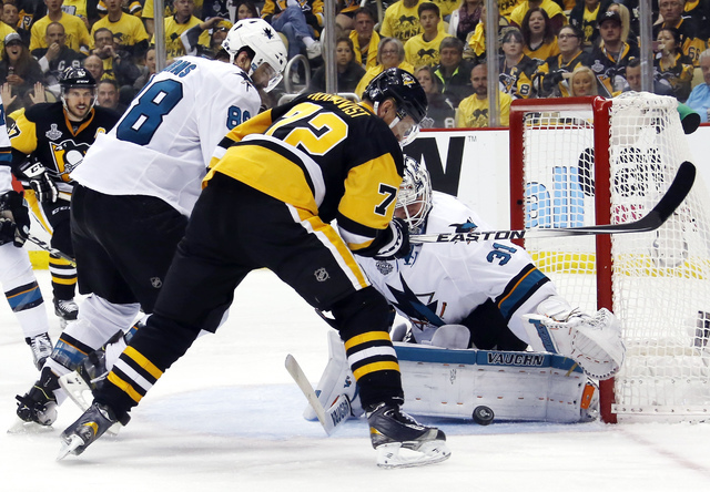 San Jose Sharks goalie Martin Jones (31) turns a shot away as Pittsburgh Penguins' Patric Hornqvist (72) and Sharks' Brent Burns (88) scramble in front of the net during the third period in Game 5 ...