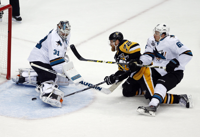 San Jose Sharks goalie Martin Jones (31) turns away a shot by Pittsburgh Penguins' Patric Hornqvist (72) as Sharks' Justin Braun (61) defends during the second period in Game 5 of the NHL hockey S ...