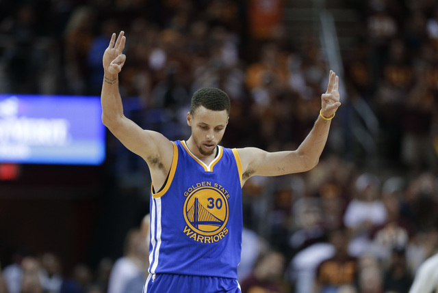 Golden State Warriors guard Stephen Curry celebrates a basket against the Cleveland Cavaliers during the second half of Game 4 of basketball's NBA Finals in Cleveland, Friday, June 10, 2016. (Tony ...