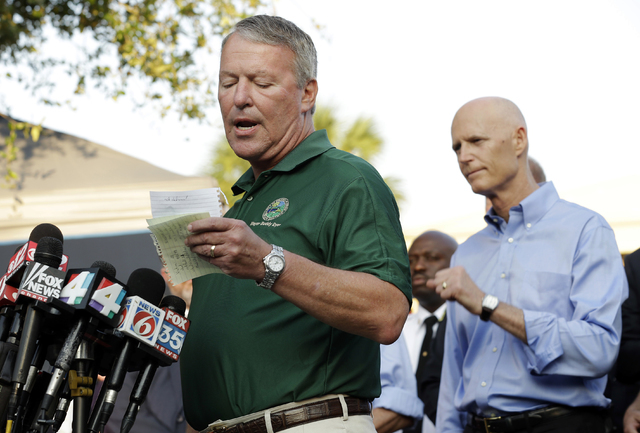 Orlando, Fla., Mayor Buddy Dyer reads details of the fatal shootings at Pulse Orlando nightclub during a media briefing Monday, June 13, 2016, in Orlando. Looking on is Florida Gov. Rick Scott at  ...