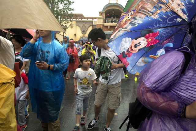 Visitors arrive on the opening day of the Disney Resort in Shanghai, China, Thursday, June 16, 2016. Walt Disney Co. opened its first theme park in mainland China on Thursday at a ceremony that mi ...