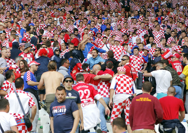 Croatia's team fans run in the stands after flares were thrown onto the pitch during the Euro 2016 Group D soccer match between the Czech Republic and Croatia at the Geoffroy Guichard stadium in S ...