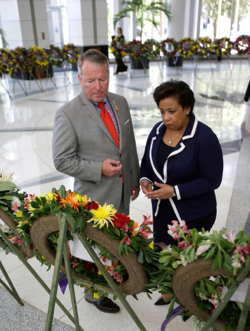 Orlando mayor Buddy Dyer, left, and Attorney General Loretta Lynch view a memorial at City Hall of 49 wreaths, one for each victim of the Pulse nightclub mass shooting, Tuesday, June 21, 2016, in  ...
