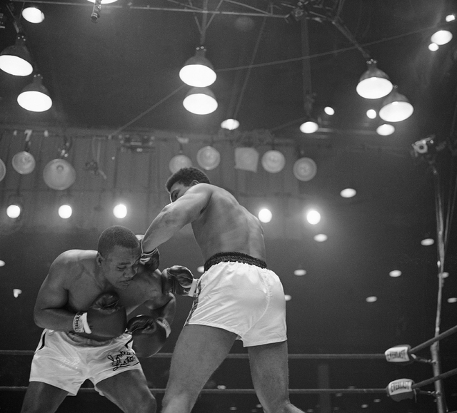 Muhammad Ali (Cassius Clay), right, lands both gloves on the left shoulder of Sonny Liston in an early of their scheduled 15-round heavyweight championship fight in Miami Beach, Florida on Feb. 25 ...