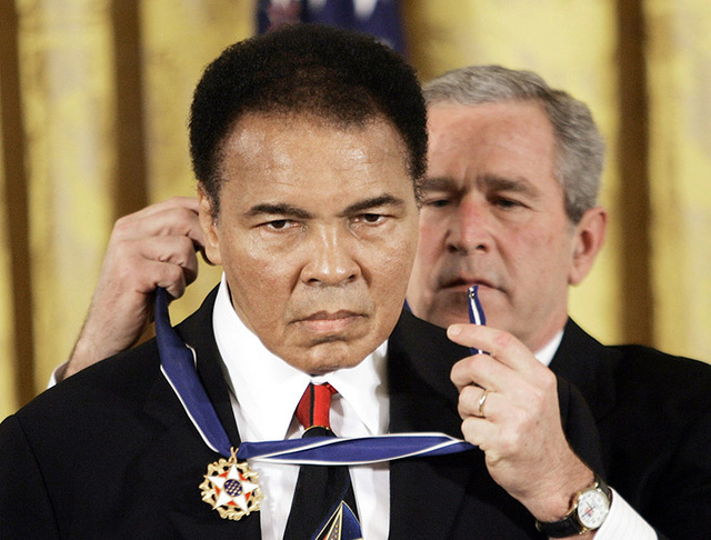 President Bush presents the Presidential Medal of Freedom, Wednesday, Nov. 9, 2005, to boxer Muhammad  Ali in the East Room of the White House.  (Evan Vucci/AP)