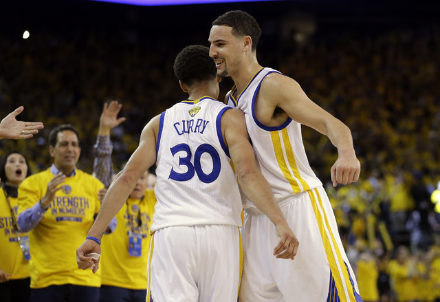Golden State Warriors guard Stephen Curry (30) celebrates with guard Klay Thompson during the second half of Game 5 of the NBA Finals against the Cleveland Cavaliers in Oakland, Calif. on June 14, ...