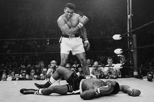 Heavyweight champion Muhammad Ali stands over fallen challenger Sonny Liston, shouting and gesturing shortly after dropping Liston with a short hard right to the jaw on May 25, 1965, in Lewiston,  ...