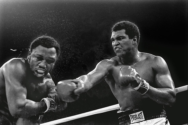 Spray flies from the head of challenger Joe Frazier as heavyweight champion Muhammad Ali connects with a right in the ninth round of their title fight in Manila, Philippines, October 1, 1975.  Ali ...