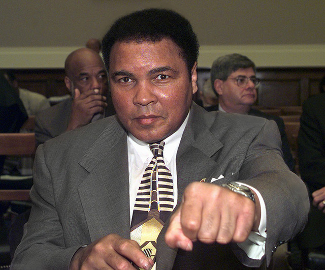 Former heavyweight boxing champ Muhammad Ali throws a punch prior to appearing on Capitol Hill Thursday March 26, 1998 before the House Commerce Committee hearing on Parkinsons disease research. A ...