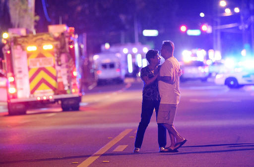 Family members wait for word from police after arriving down the street from a shooting involving multiple fatalities at Pulse Orlando nightclub in Orlando, Fla., Sunday, June 12, 2016. (Phelan M. ...