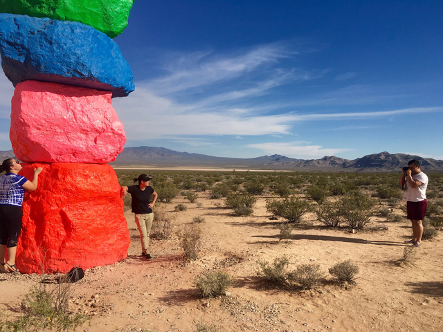 People take pictures at the Seven Magic Mountains art project off Interstate 15 on Sunday, June 5, 2016. (Natalie Bruzda/Las Vegas Review-Journal)