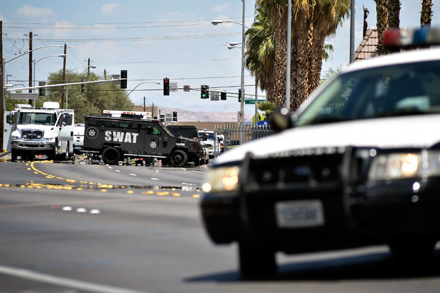 Las Vegas police stand guard during a barricade situation at the Siegel Suites along Twain Avenue near Swenson Street Monday, June 13, 2016, in Las Vegas. (David Becker/Las Vegas Review-Journal Fo ...