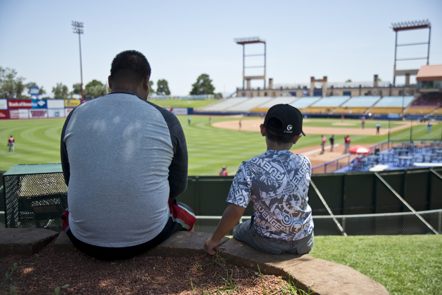 Jonathan Morales, left, and Alex Valdez stay cool in the shade during the Las Vegas 51s baseball game against the Tacoma Rainiers at Cashman Field on Tuesday, June 7, 2016. (Daniel Clark/Las Vegas ...