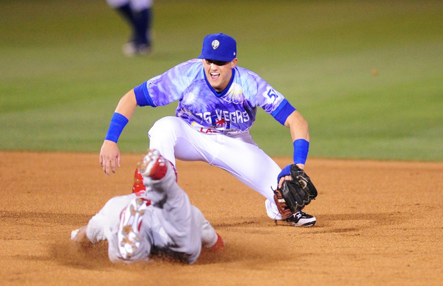 Las Vegas 51s shortstop Gavin Cecchini tags out Memphis Redbirds batter Tommy Pham at second base after Pham tried to stretch a single into a double in the sixth inning of their minor league baseb ...