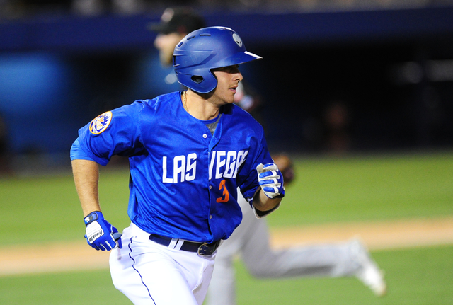 Las Vegas 51s batter T.J. Rivera hits an RBI sacrifice fly ball against the Nashville Sounds in the fourth inning of their minor league baseball game at Cashman Field in Las Vegas Monday, May 23,  ...