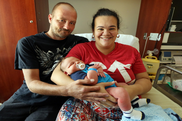 Moses William Hilton is held by his parents Leslie and Gina Hilton at Hutchinson Regional Medical Center, in Hutchinson, Kan. Moses weighed over 14 pounds when he was born on June 2, at the hospit ...
