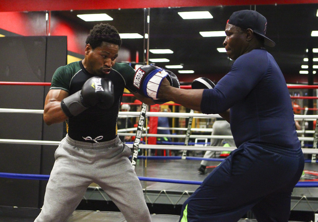 Shawn Porter, left, trains with his father, Kenny Porter, at Porter Hy-Performance Center, 2206 Paradise Road, in Las Vegas on Wednesday, June 8, 2016. Porter is slated to fight Keith Thurman on J ...