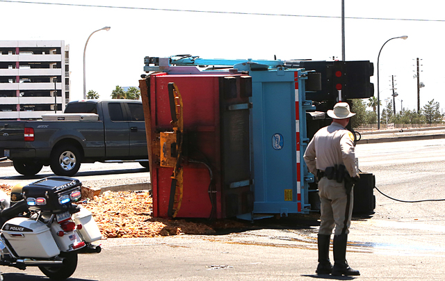 A semitrailer overturned near Sahara Avenue and Northbridge Street on Monday, June 6, 2016. The truck was full of feed headed to the pig farm near North Las Vegas. (Bizuayehu Tesfaye/Las Vegas Rev ...