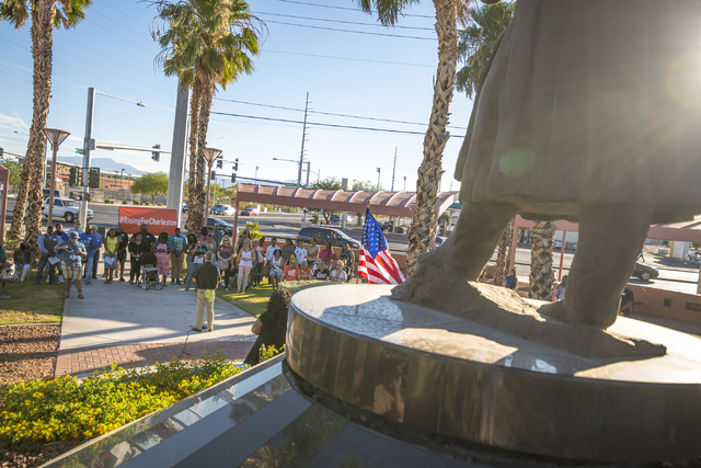 People participate in an anniversary prayer vigil for the victims of the Charleston church shooting at the corner of Martin Luther King Boulevard and West Carey Avenue on Friday, June 17, 2016. Jo ...