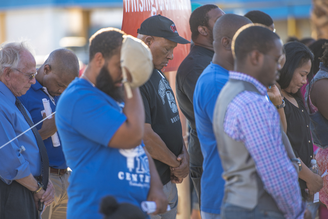 People participate in an anniversary prayer vigil for the victims of the Charleston church shooting at the corner of Martin Luther King Boulevard and West Carey Avenue on Friday, June 17, 2016. Jo ...