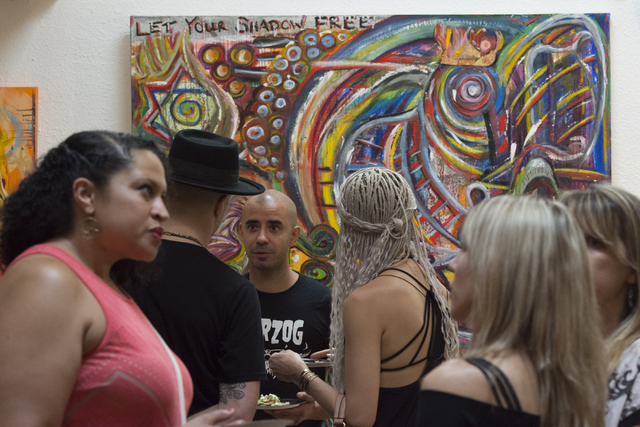 Artists and patrons mingle during the reception for "The Collective" art show at EDEN Art Studio and Gallery at The Arts Factory in Las Vegas Thursday, June 2, 2016. The show's artists are employe ...