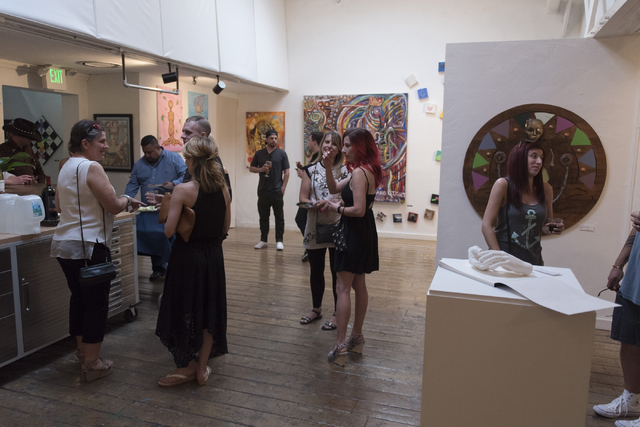 Artists and patrons mingle during the reception for "The Collective" art show at EDEN Art Studio and Gallery at The Arts Factory in Las Vegas Thursday, June 2, 2016. The show's artists are employe ...