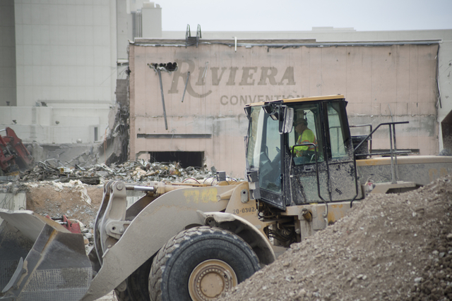 A worker drives a construction vehicle as crews work to demolish parts of the Riviera hotel-casino in Las Vegas on Friday, May 20, 2016. The two main towers are scheduled to be imploded in June an ...